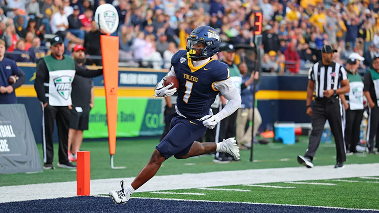 Toledo Rocket football player runs into the end zone for a touchdown.