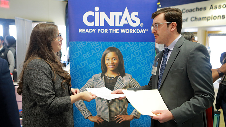 Rebecca Kahl of Cintas, left, exchanges information with Jimmy Goodyear, an undergraduate student studying professional sales, at the Neff College of Business’ Spring 2025 Job Fair.
