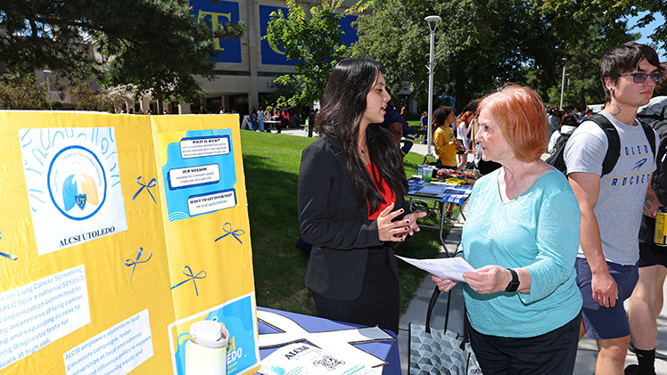 Saakshi Risam, left, a junior health sciences major, speaks to Sandy Whitman, an executive assistant in the John B. and Lillian E. Neff College of Business and Innovation, during the Campus Involvement Fair on Centennial Mall. Risam recently launched a UToledo chapter of the American Lung Cancer Screening Initiative.