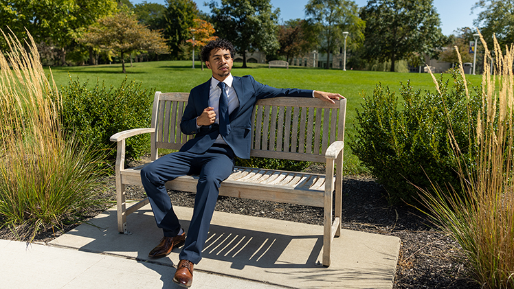 Portrait of Utoledo freshman engineering student Tyreese Blue II sitting on a bench on Centennial Mall. Blue was selected Ohio Youth of the Year by the Boys and Girls Club of America. 
