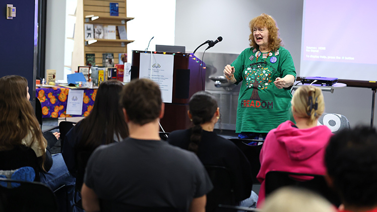 Dr. Paulette D. Kilmer, a retired UToledo faculty member and coordinator of the UToledo Banned Books Coalition, speaks to students, staff and community members Thursday at the 28th Annual Banned Books Week Vigil in Carlson Library.