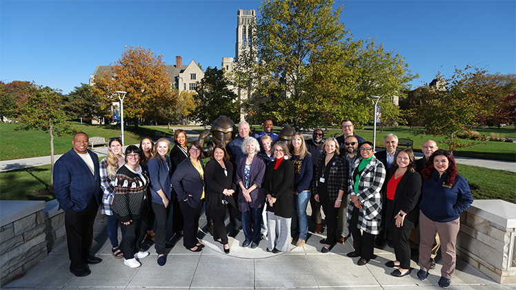 UToledo faculty and staff who were first-generation college students pose for a group photo Monday on the new mascot plaza as part of the University's celebration of first-generation college students.