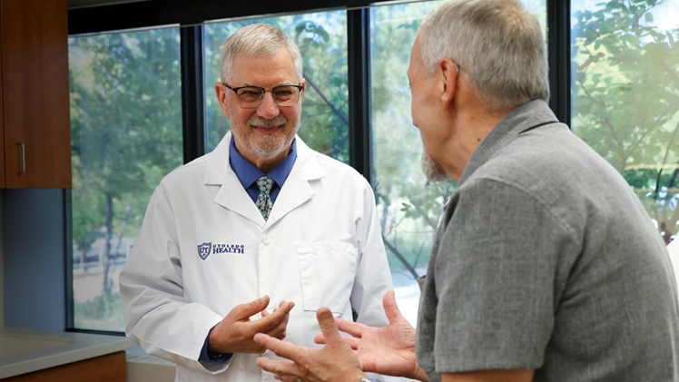 Portrait of UToledo UToledo Distinguished University Professor Blair Grubb talking with his patient Chris-Bowers in Grubb's office.