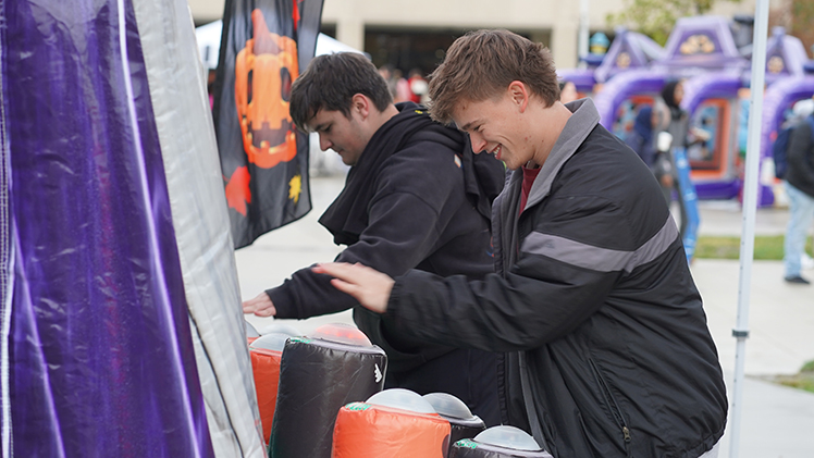 Tobias Domitrovich, right, a freshman studying biology, and Erik Wingertsahn, a freshman studying mechanical engineering, enjoy a Halloween-themed game at the annual Fall Fest event on Centennial Mall.