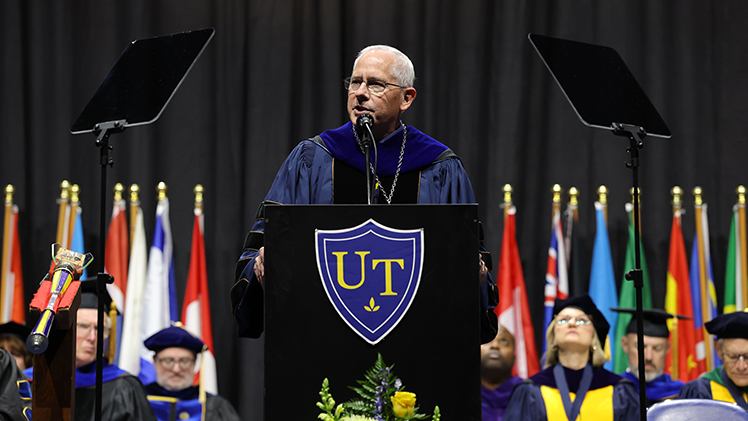 Dr. James Holloway speaks at a podium during his Inauguration as 19th president of The University of Toledo.