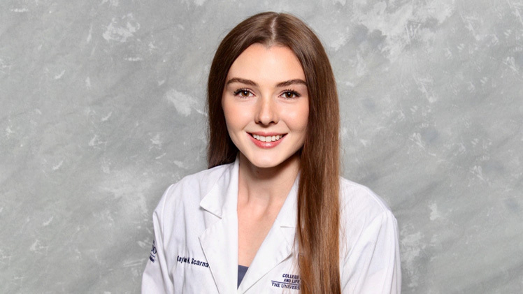 Headshot of Kaylee Scarnati, a fourth-year medical student who is wearing her UToledo MLS coat. 