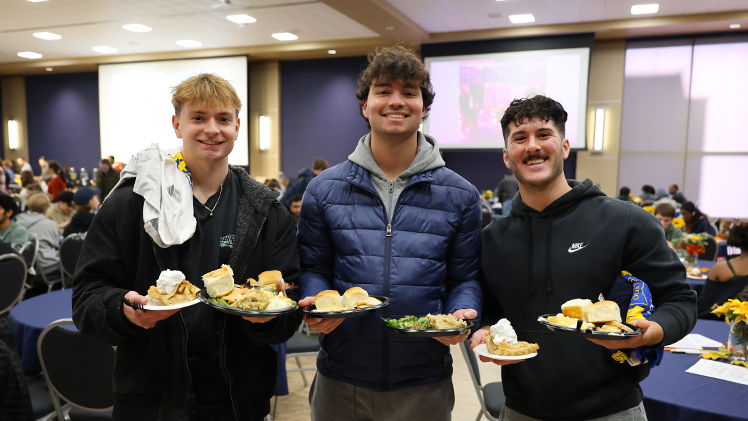 From left, Ryan Robertson, Gabe Marlow and Dylan Hershey, all first-year graduate students in physical therapy, with their Thanksgiving lunches.
