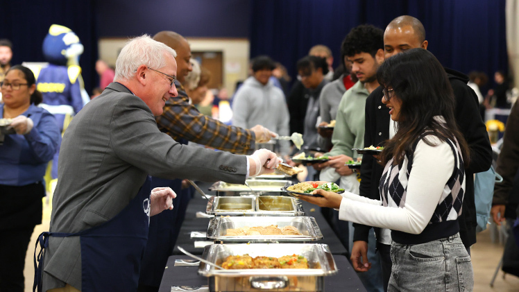 President Holloway serves a portion of turkey to Afifah Nilima, a junior working towards a bachelor of business administration in finance and accounting, at the annual President’s Thanksgiving Lunch for the UToledo community on Monday, Nov. 17, in Thompson Student Union Auditorium.