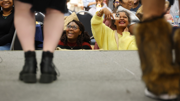 UToledo KPop Club members Jayla Gilbert, a sophomore in psychology, and Keyera Cagle, a sophomore in early childhood education, enjoy a performance by the kPop Dance Team UToledo Daebak during the International Students Association’s I-Village on Wednesday at Thompson Student Union Auditorium.
