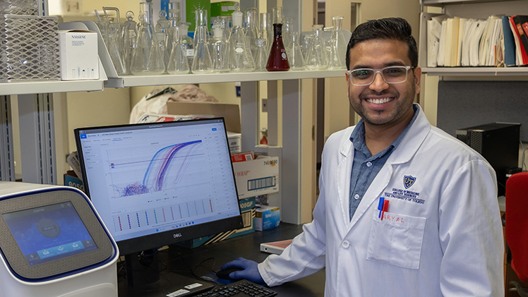 Portrait of Sachin Aryal in a lab conducting research. He graduates Dec. 13 with his doctorate in molecular medicine.