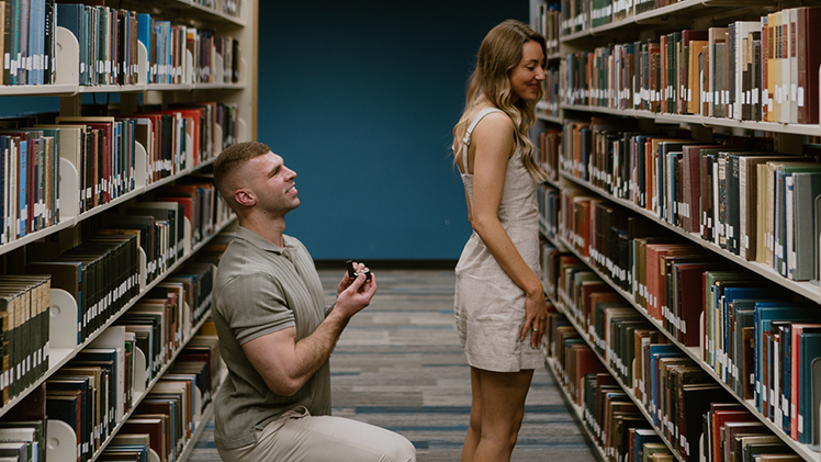 When Conner proposed to Ali, he chose a place that meant everything to them: Carlson Library. On the same floor where they had first studied side by side, he got down on one knee during a birthday photoshoot Ali had arranged as a surprise.