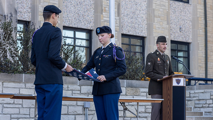 Members of the UToledo Army ROTC color guard, from left, Patrick Kovach, a sophomore in political science major, and Cadet Ingrid Harmon, a senior in exercise science, properly dispose of an American flag that is no longer suitable for display as part of a flag retirement ceremony Wednesday afternoon in Centennial Mall.