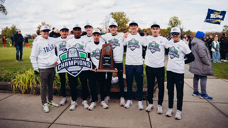 Toledo Men's Cross Country poses with the trophy after winning their second consecutive Mid-American Conference Men's Cross Country Championship in Buffalo, N.Y. on Saturday.