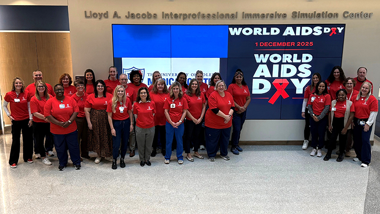 Photo of the UToledo Health Care Clinic team community to wearing red to show their support for World AIDS Day.