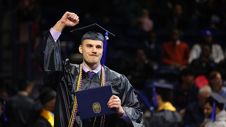 Mark Garcia celebrates after receiving his bachelor’s degree in information systems cum laude during the morning ceremony.