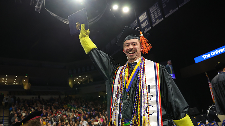 Nathan Simpkins shows off his bachelor's degree in bioengineering during the Saturday, Dec. 13, afternoon fall commencement ceremony.