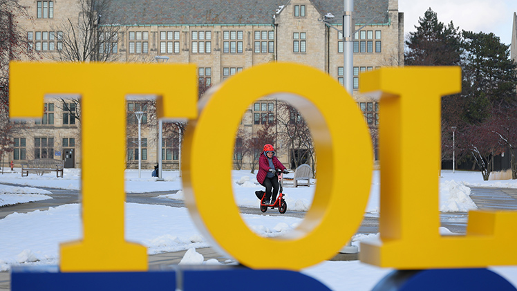 Zoe Boninsagna, a junior studying communication, zips around Centennial Mall on a cold Tuesday afternoon.