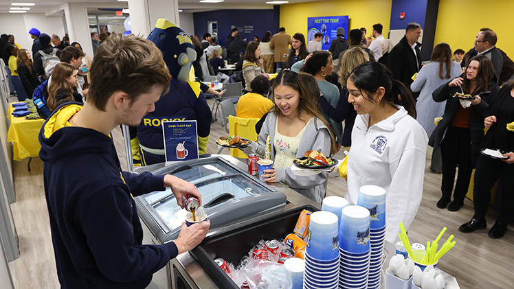 Graduate Assistant Josh Tienvieri prepares ice cream drinks for Meling Bond (Junior majoring in Health Sciences, pre-PA) and Sanjna Singhal (Junior majoring in Biology).