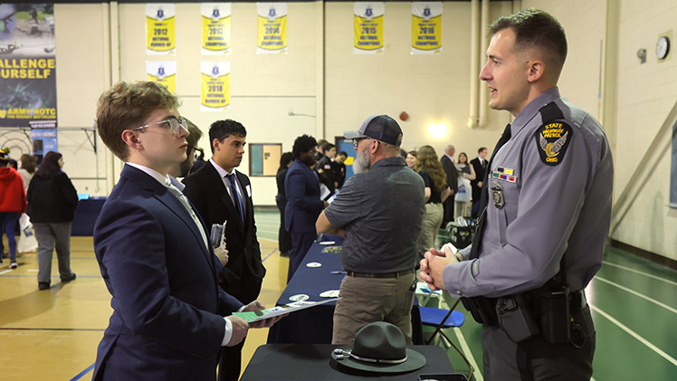 Logan Berger, a sophomore majoring in criminal justice, speaks with Ohio State Highway Patrol Trooper Dalton Surbey during the Public Service Career and Internship Fair on Thursday in the University’s Health Education Center.
