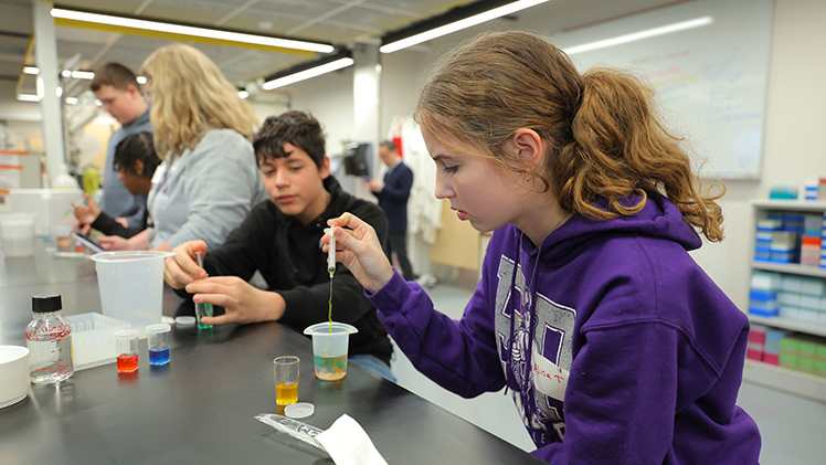 (L to R) Jamir Hughes watches as, Alise Tooman (Fremont Ross)creates alginate beads (biodegradable, gel-like spheres used in things like Boba Tea) during the Introduce a Middle Schooler to Engineering event.