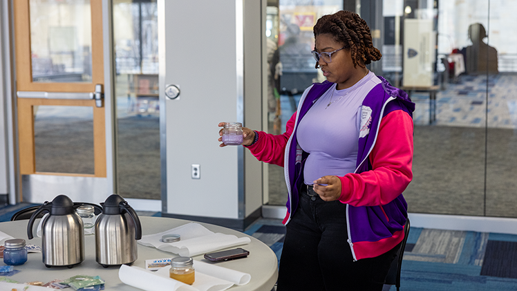 Ronetta Bell-Moore, a senior studying speech-language pathology, puts the finishing touches on her calm jar.