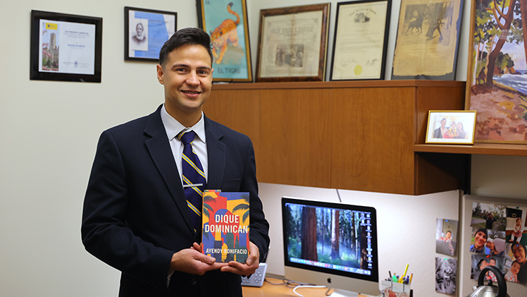 Dr. Ayendy Bonifacio holds a copy of his new memoir, “Dique Dominican.”