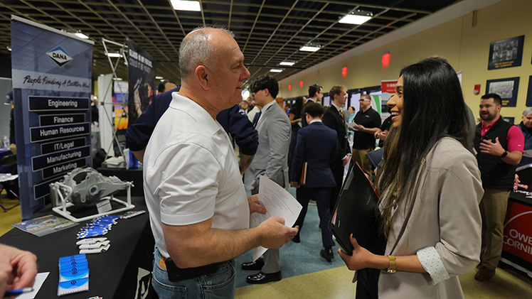 Stan Kielar, left, a senior engineering manager for Dana, talks with Prachi Sony, a junior in computer science, at the Spring 2026 Engineering Career Expo on Thursday in Savage Arena.