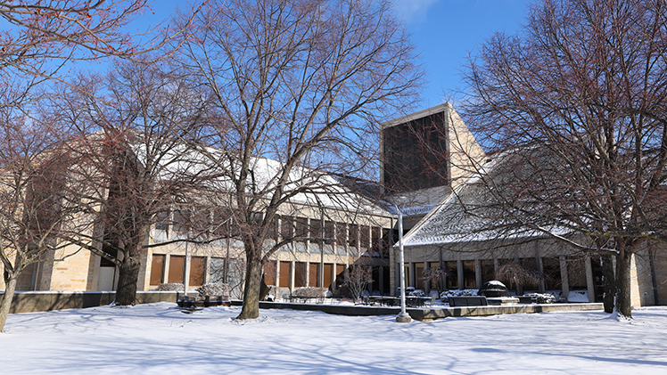 A winter beauty photo of the outside of the College of Law building with snow.