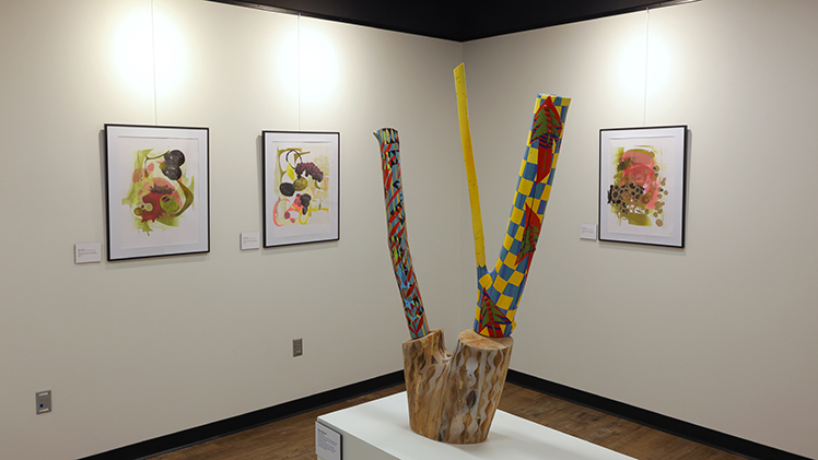 A photo of an art exhibit featuring mixed-media work by Deb A. Davis, a professor emerita, and Barbara Miner, a professor and chair of the Department of Art, on display in Carlson Library North Gallery through Friday, March 13.