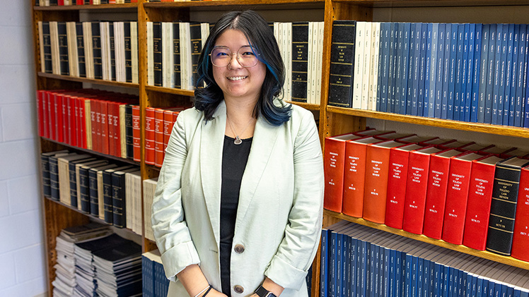 Portrait of third-year law student Lauren Wall in the law library.
