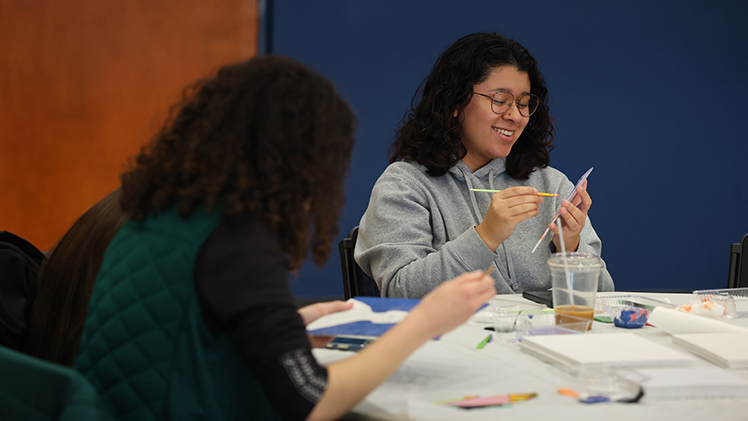 Jessica Martinez, a sophomore in criminal justice, paints a landscape during the DIY-style event.