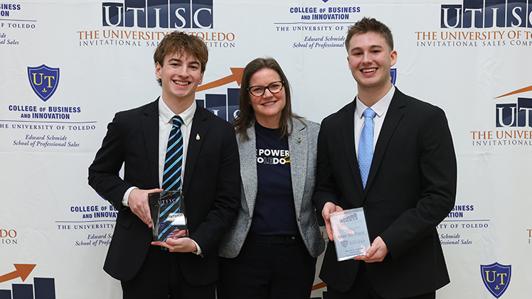 Left to right, junior Colin Fitzgerald, Dr. Barbara Ritter, dean of the Neff College of Business, and sophomore Joseph Szymanski pose at the annual sales competition. The 2 students are holding awards they received at the event.