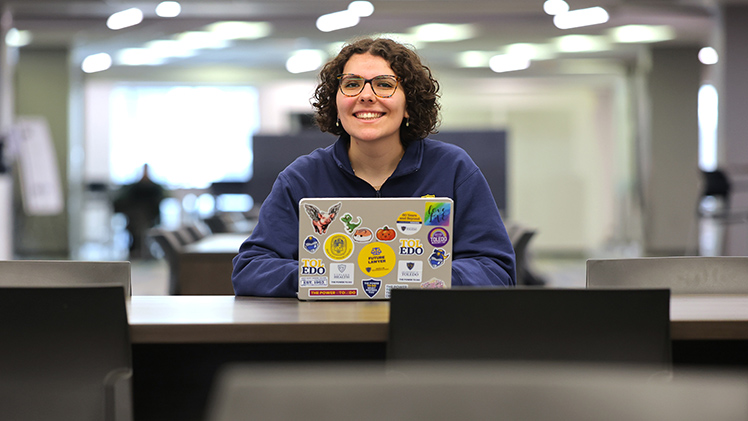 UToledo sophomore Tabitha Romer on her computer in the library