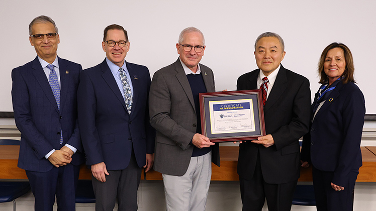 From left, Dr. Imran Ali, dean of the College of Medicine and Life Sciences; Dr. Mitchell McKinney, UToledo provost; Dr. James Holloway, UToledo president; Dr. Jian-Ting Zhang, a professor and the inaugural director of the Northwest Ohio Cancer Research Institute; and Dr. Grace Bochenek, vice president of research.