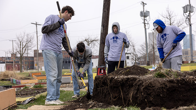 From left, Duncan McLean, a junior studying fine arts; Payton Saputl, a sophomore studying chemical engineering; Evan Ruhe, a freshman studying civil engineering; and Josh Fugate, a freshman studying civil engineering, work on a plant bed at Manos Community Garden in downtown Toledo during Saturday's BIG Event.