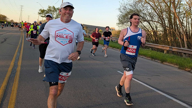 Michael Green, left, UToledo director of sustainability and energy efficiency, and Liam Walsh, assistant director of annual giving, run in a Glass City Marathon.