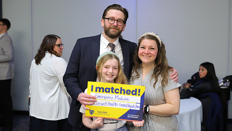 Nick Bunda, who matched in emergency medicine with Corewell Health in Grand Rapids, celebrates with his wife, Jeannette, and daughter, Sloane.