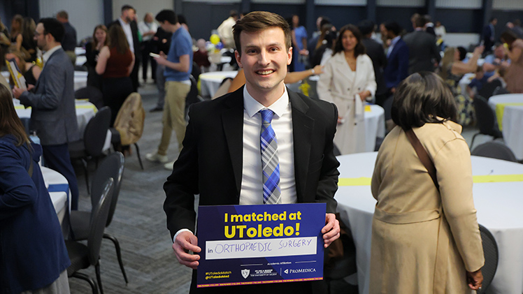 Matthew Folkman, who matched with UToledo’s Orthopedic Surgery Residency program, holds up his Match Day sign.