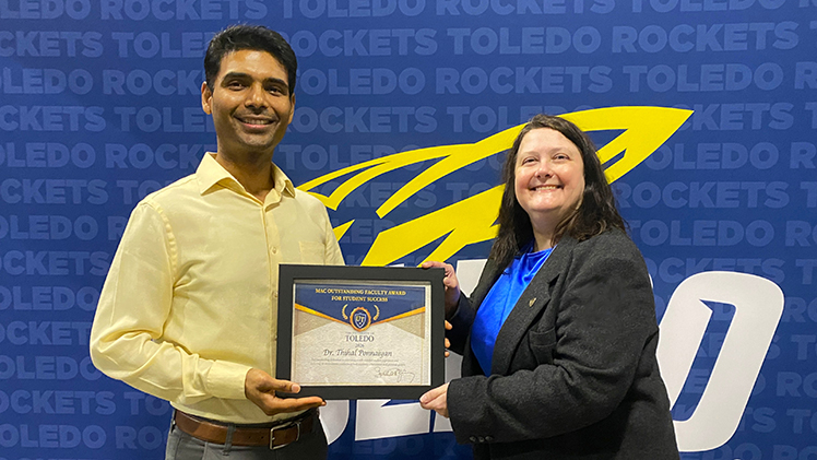Dr. Thehazhnan “Thihal” Ponnaiyan, a senior lecturer and undergraduate director in the Department of Chemical Engineering, receives the UToledo’s 2025-26 Mid-American Conference Outstanding Faculty Award for Student Success from Dr. Jeanne Kusina, a Distinguished University Lecturer and director of The Center for Excellence in Teaching and Learning.