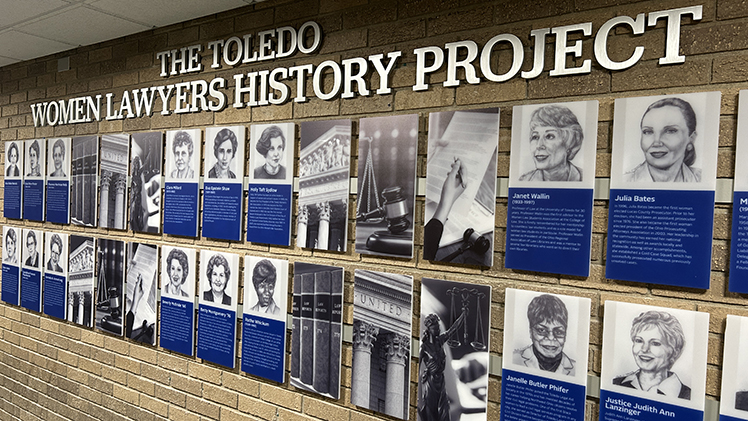 A photo of the a wall of photos displayed as part of the Toledo Women Lawyers History Project, housed at The University of Toledo College of Law, which was created to preserve and document the stories of women who helped shape the region’s legal profession.