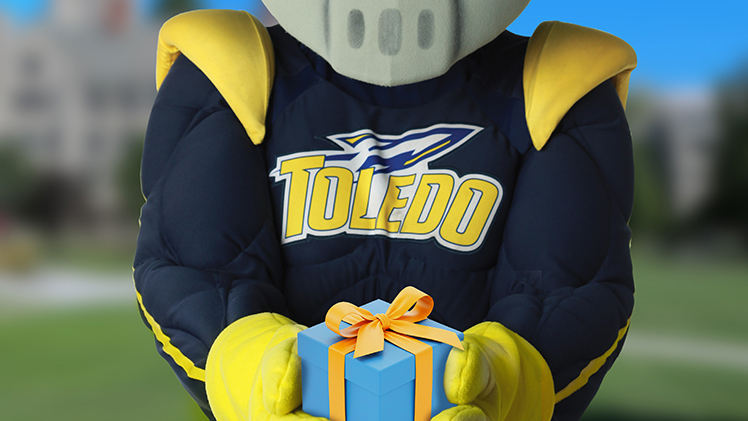 Image of Rocky holding a present.