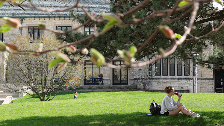 Faith Kern, a sophomore studying environmental science, enjoys a cold beverage on a warm spring afternoon earlier this week in Centennial Mall.