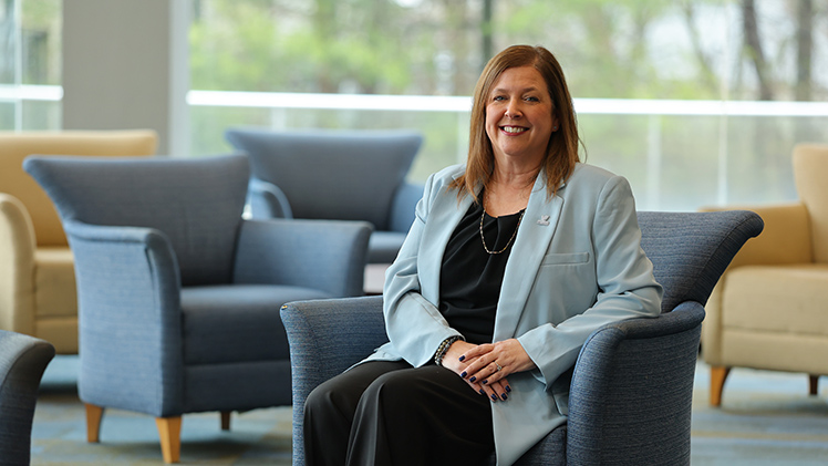 Portrait of Jennifer Archer, who utilized the University’s employee tuition benefit to earn her M.B.A., balancing a demanding career and family life to walk across the commencement stage Friday, May 1.