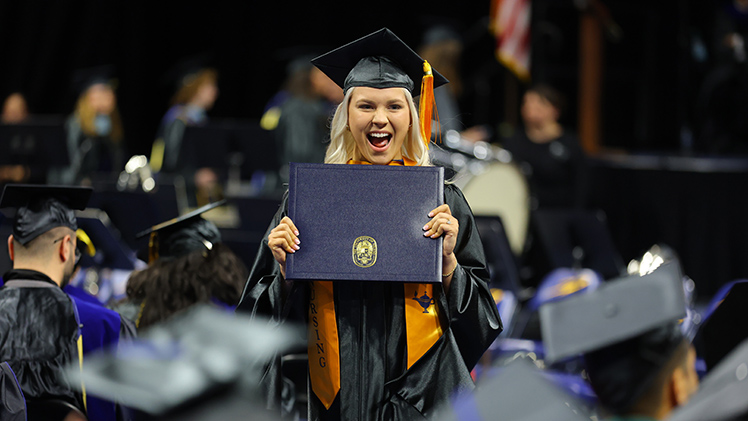 Danielle Vandevelde displays her diploma case after graduating with a Master of Science in Nursing degree.