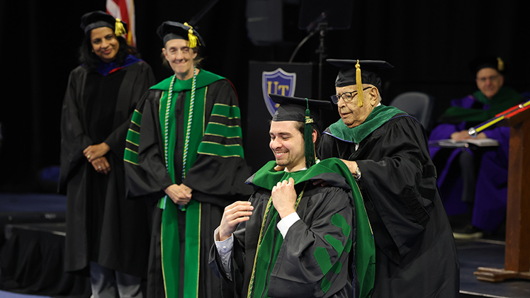Dr. Ethan Kosco is hooded during the ceremony, the final event of UToledo’s 2026 graduation season.