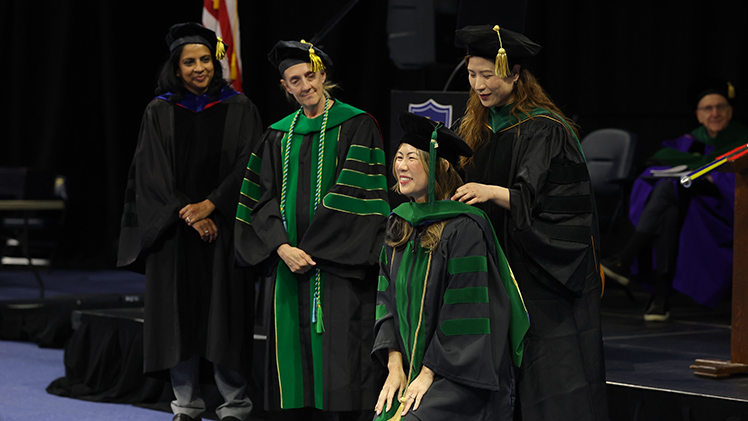 The University of Toledo College of Medicine and Life Sciences held its 2026 spring commencement ceremony on Friday at John F. Savage Arena, celebrating the newest class of healthcare professionals. Below, Dr. Lisa Rui Zhang is hooded during the ceremony.