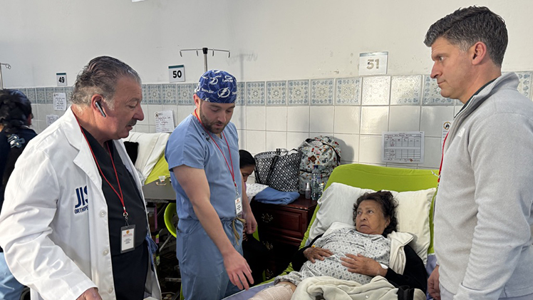 Dr. Jacob Alexander, center,,during a surgical debrief following an orthopaedic operation