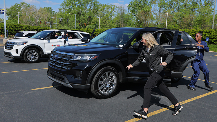 From left, Adrienne Justen, a registered dietician for UTMC, and Arlene Hampton, a licensed practical nurse, run in the team race to see who can get seated and buckled the fastest.
