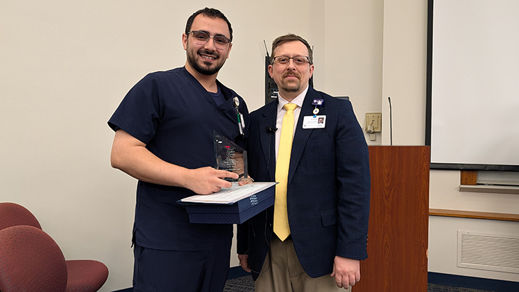 Yazan Abdulkareem, left, a staff nurse in the fifth-floor intermediate care unit who is entering his second year at UToledo Health, and Kurt Kless, UTMC’s chief nursing officer.