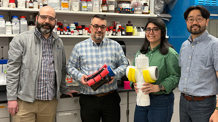 The research team of, from left, Dr. Yakov Lapitsky, professor and chair of Chemical Engineering; chemical engineering doctoral student Umberto A. Kober; civil and environmental engineering doctoral student Haniehsadat Barikbinby; and Dr. Youngwoo Seo, a professor in Civil & Environmental Engineering, with early prototypes for their algae-busting buoys.
